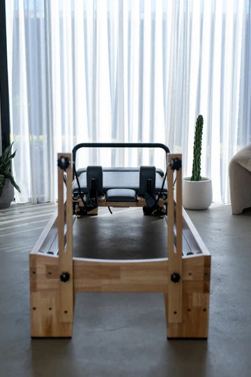 Core Collab Studio Eco Pilates Reformer, wooden frame, boutique studio setting